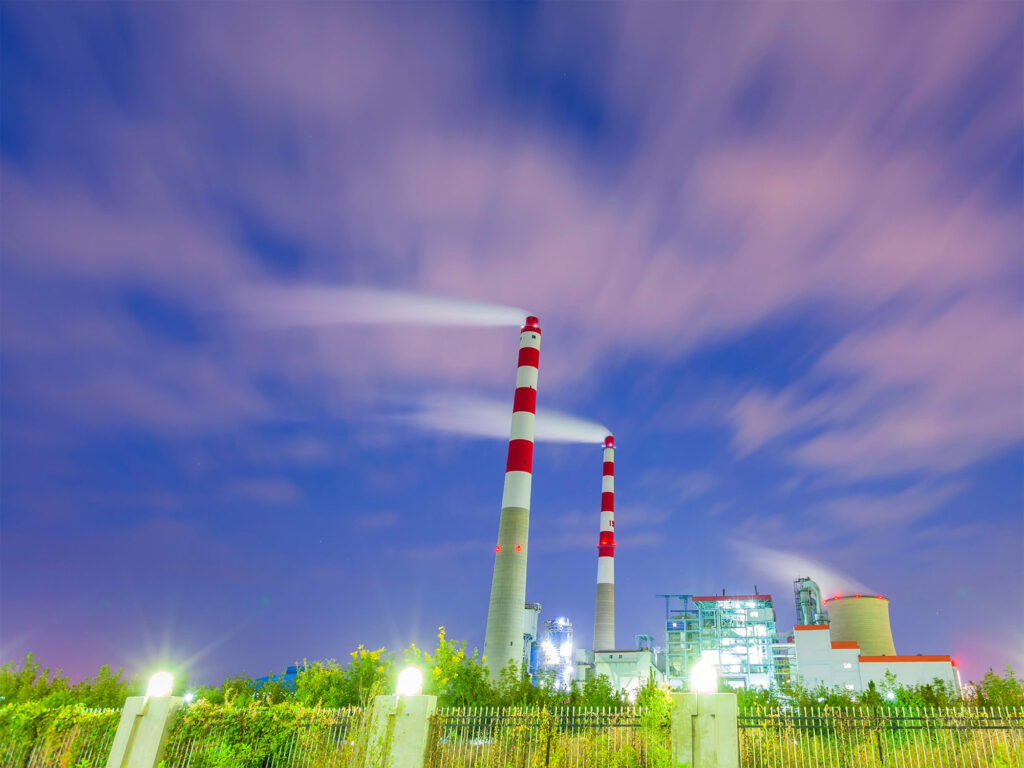 CCS - Giammarco Technologies - Large-scale industrial carbon capture (CCS) facility with smokestacks and technical infrastructure.